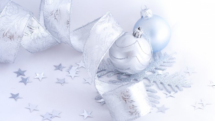 Silver and blue Christmas ornaments with ribbon and snowflake on a white background