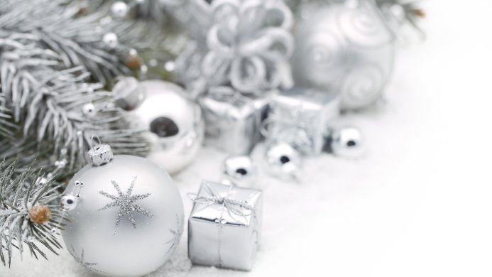 Silver Christmas ornaments, gift boxes and christmas tree branch on white background