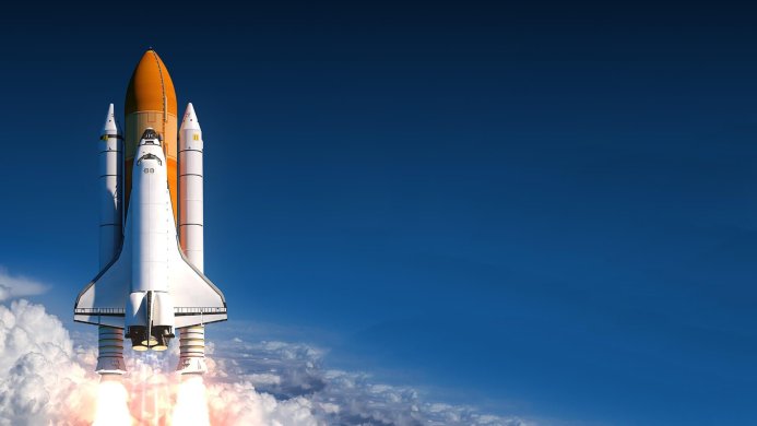 Space shuttle launching into a blue sky with clouds below
