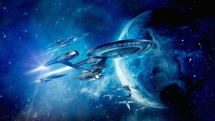 Star Trek spaceships flying in formation near a blue planet in outer space