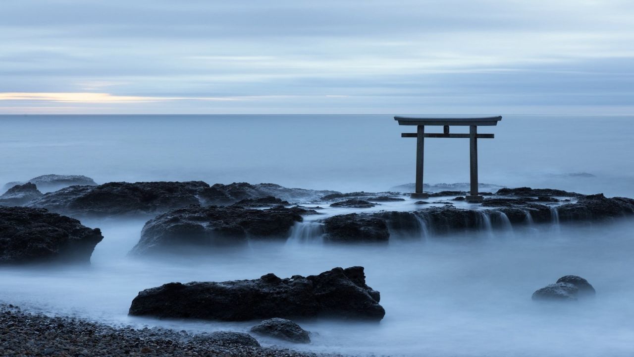 Torii gate in the sea with fog