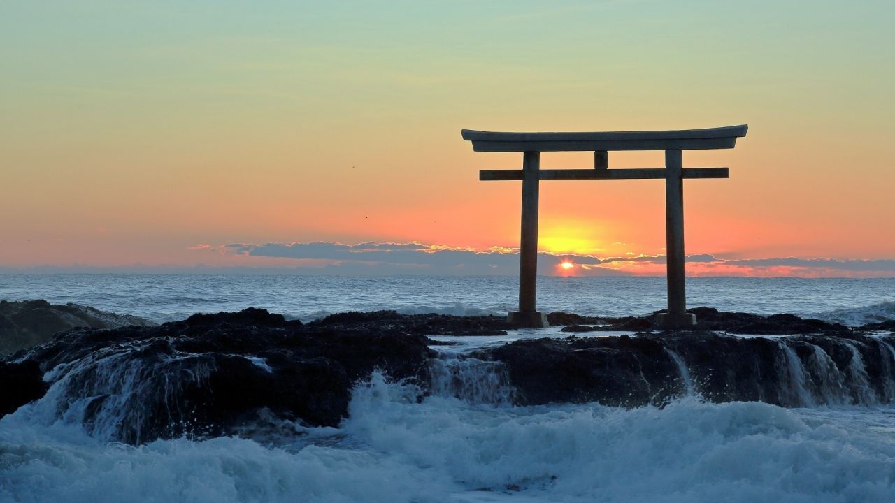 Torii gate on the sea at sunrise