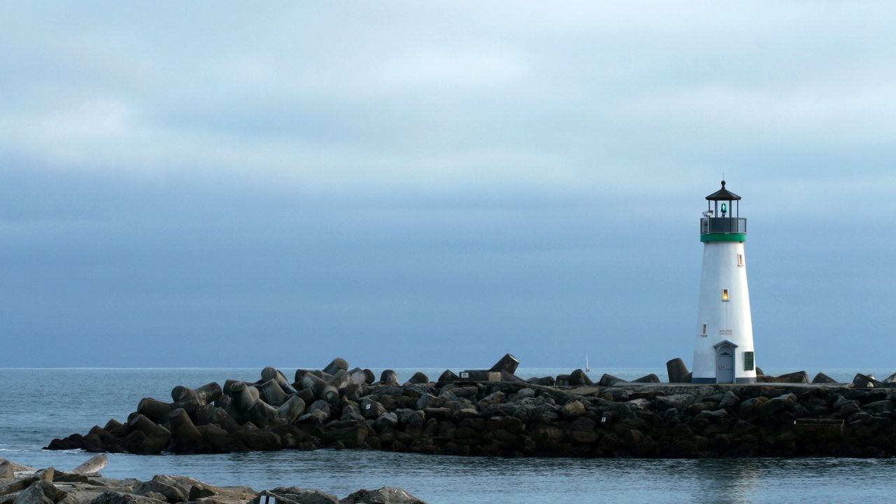White lighthouse on a rocky pier