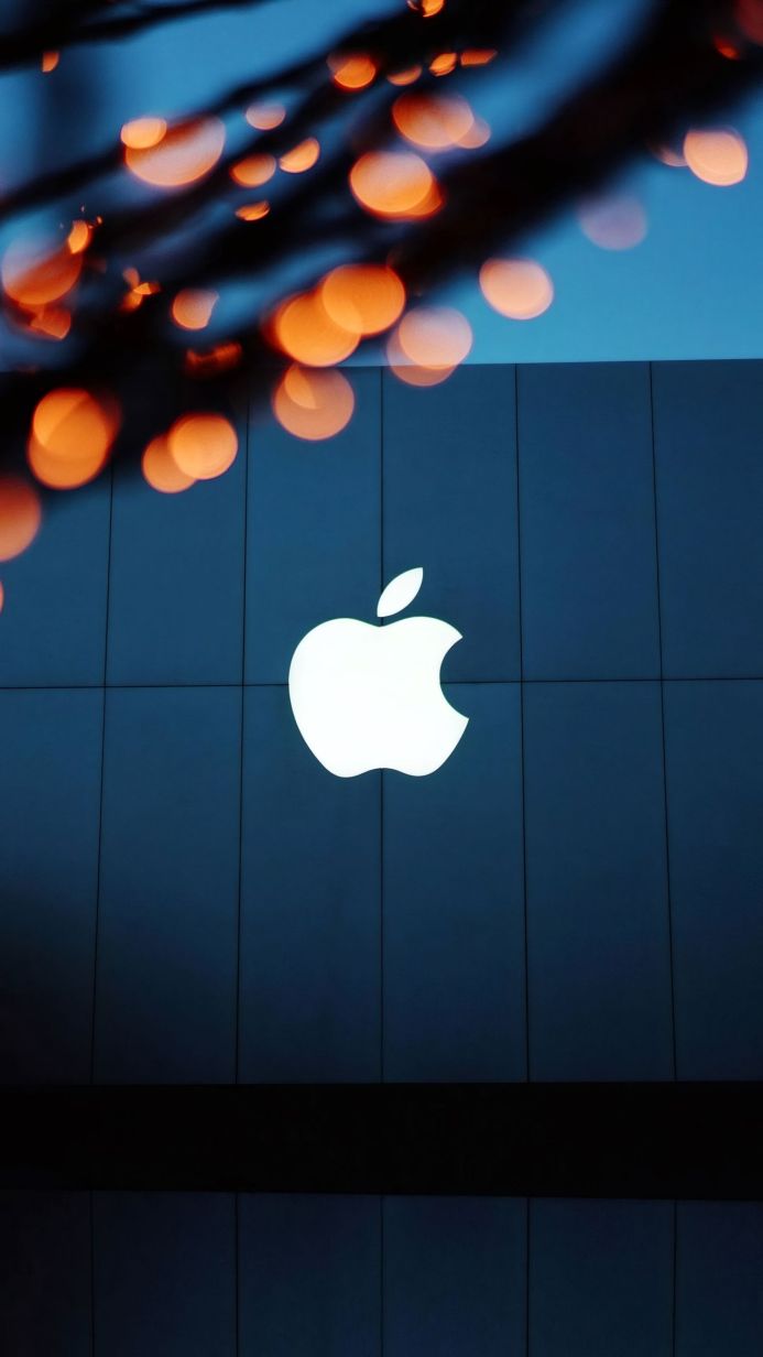 Apple logo on a building facade with bokeh lights