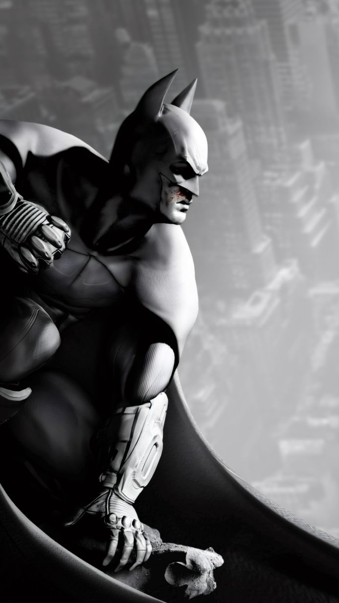 Batman perched on a rooftop overlooking Gotham City, monochrome image
