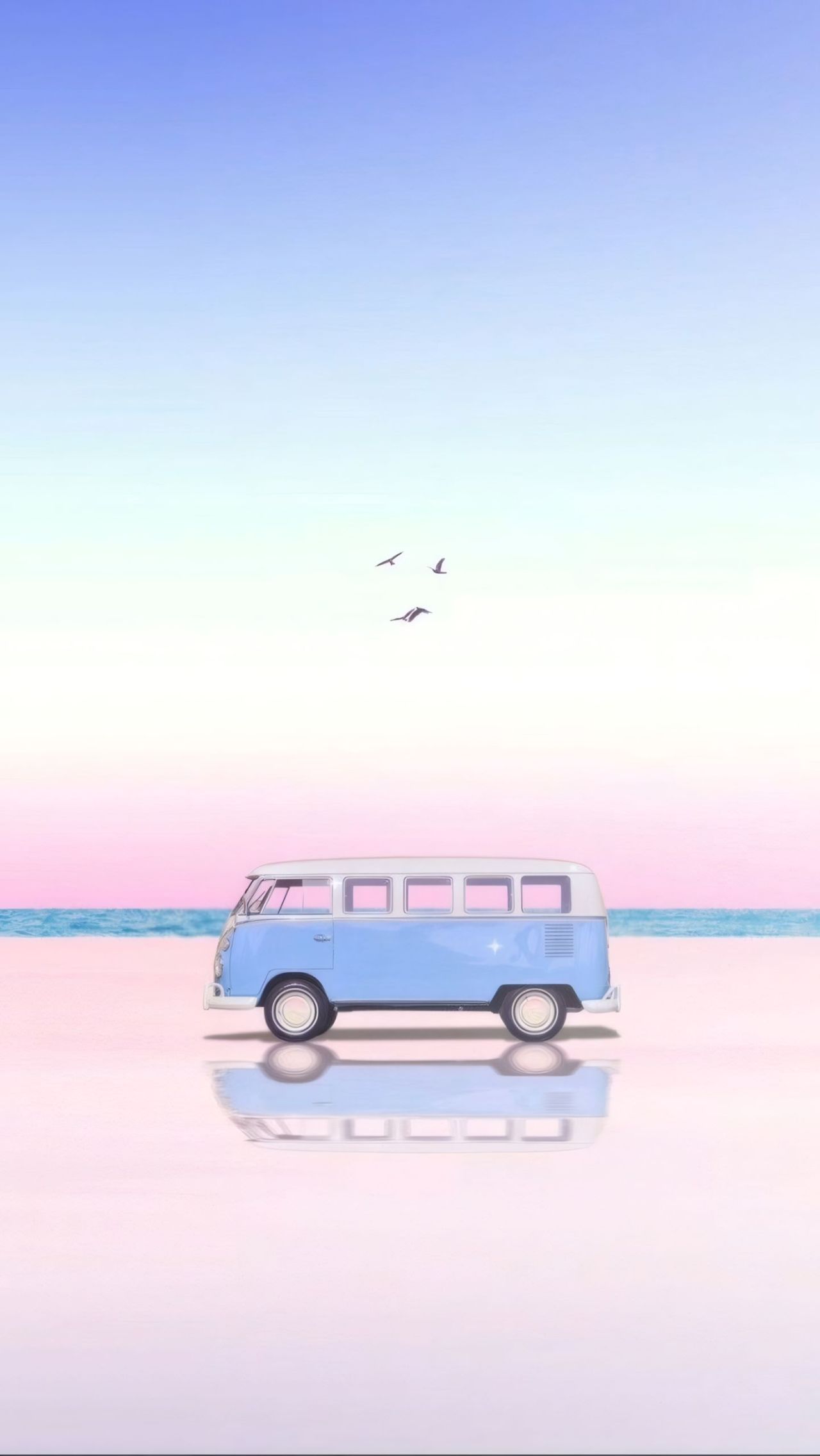 Blue Volkswagen van on a beach at sunset with birds