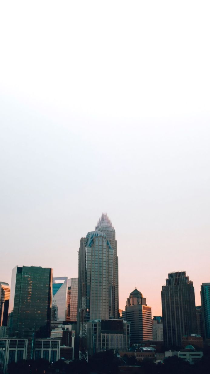 Cityscape with skyscrapers at sunset, warm light