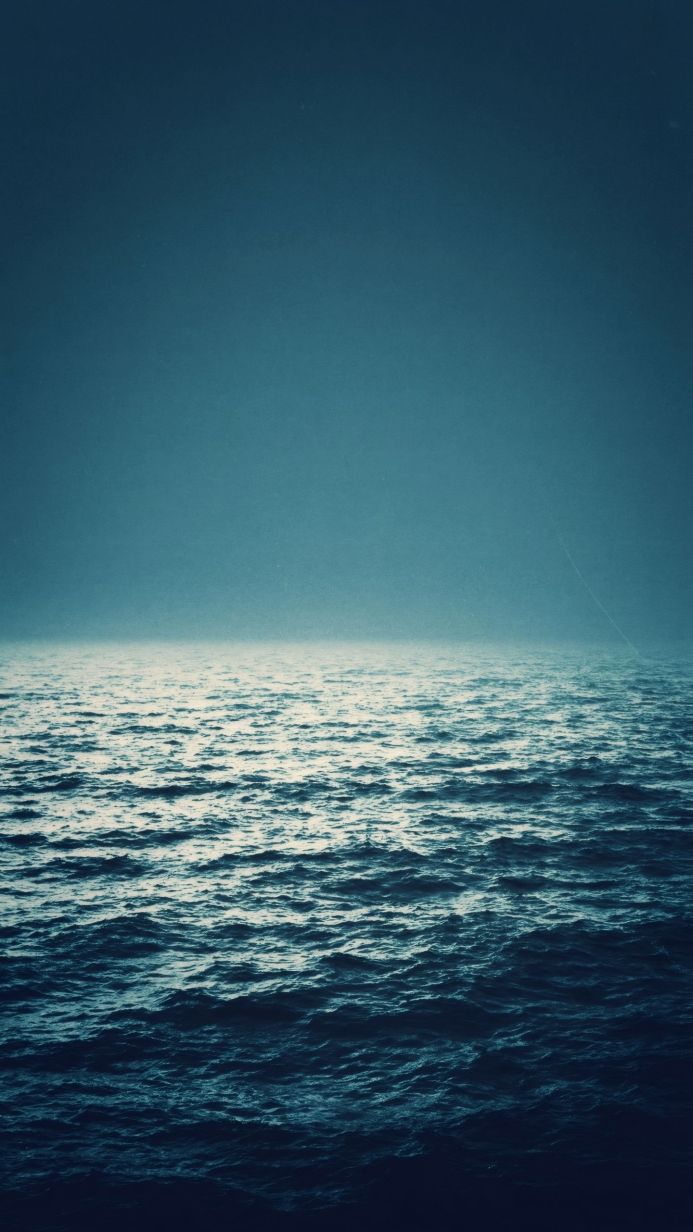 Dark blue ocean with a visible horizon line and slight waves