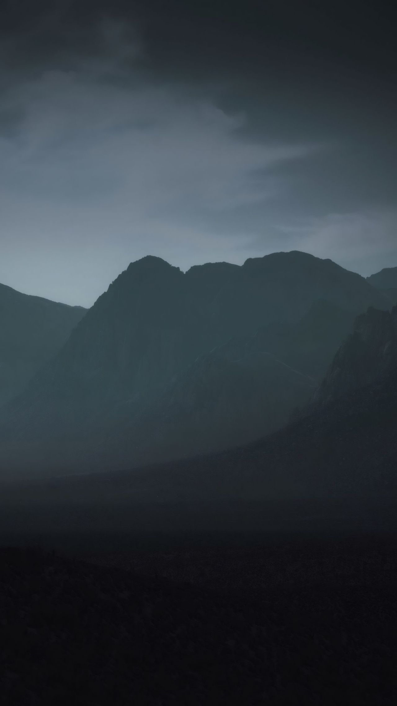Dark moody mountains cloudy sky