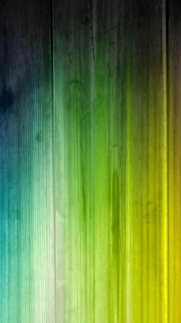 A wooden panel background with gradient colors of blue, green, yellow, and black