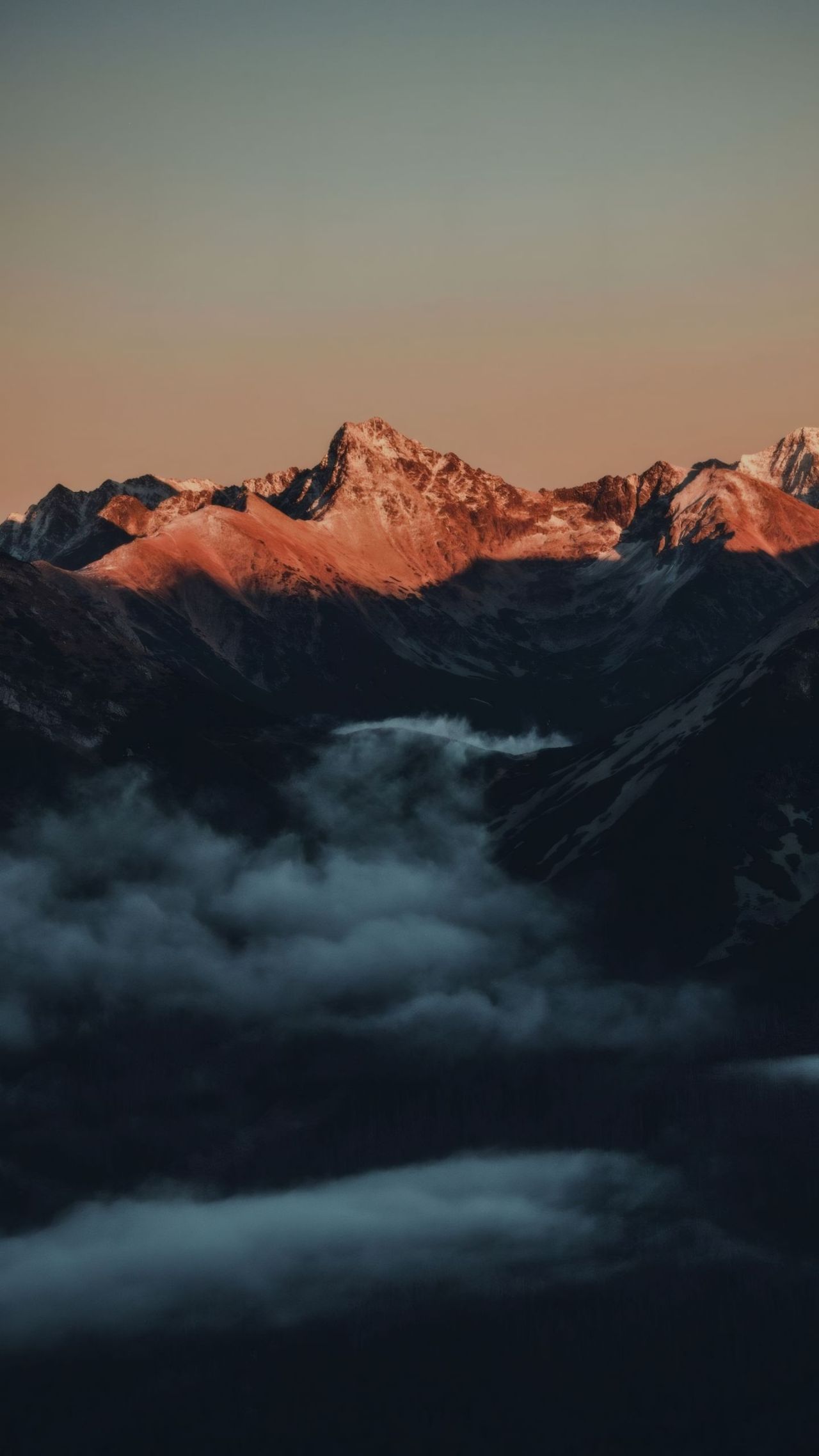 Mountains at sunset with clouds in valley