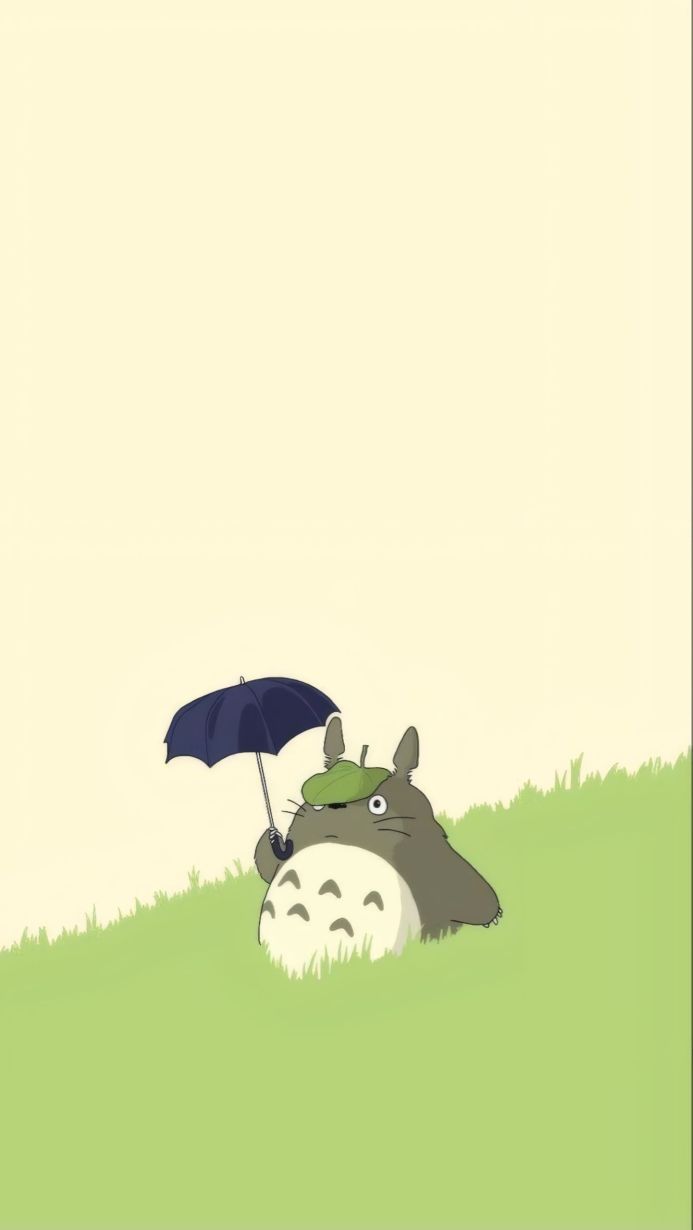 Totoro from My Neighbor Totoro holding an umbrella on a grassy hill