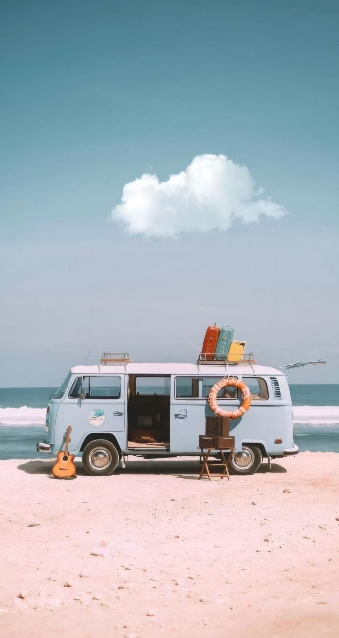 A light blue Volkswagen van on a beach with suitcases, a guitar and lifebuoy