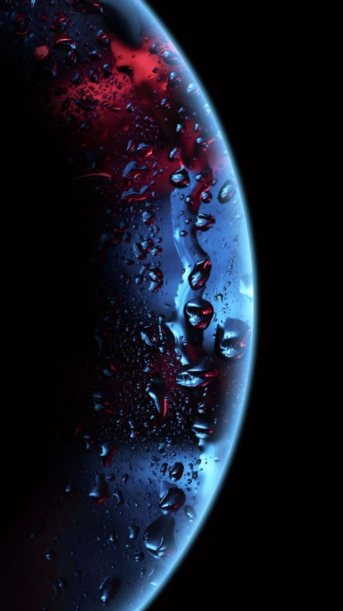 Close up of water droplets on a surface with blue and red reflections