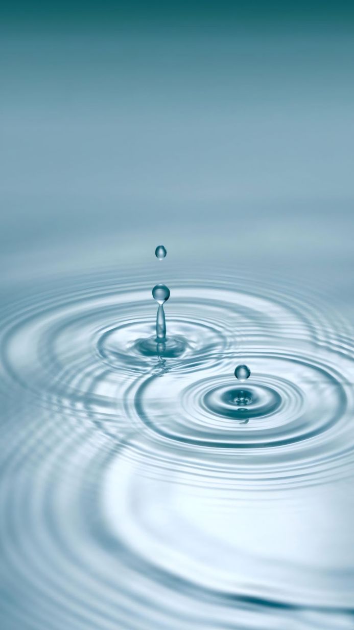 Water droplets and ripples on the surface of water creating circular patterns