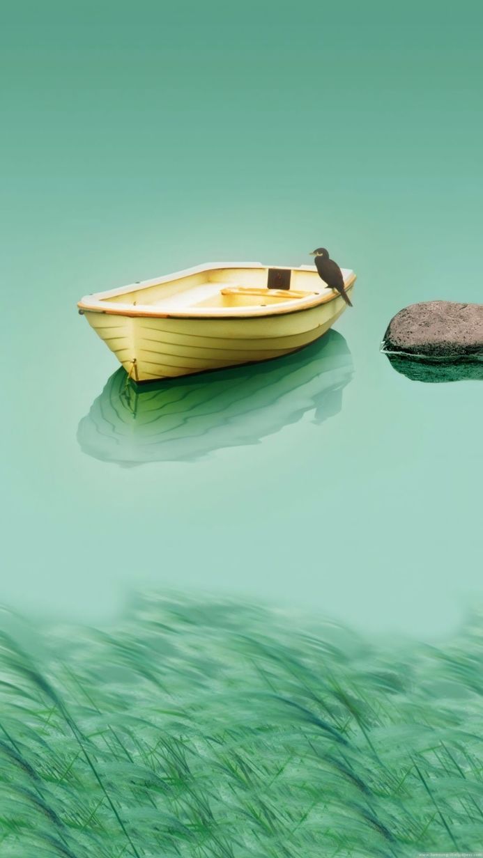 A yellow rowboat floats on green water with a black bird perched on it, near a rock