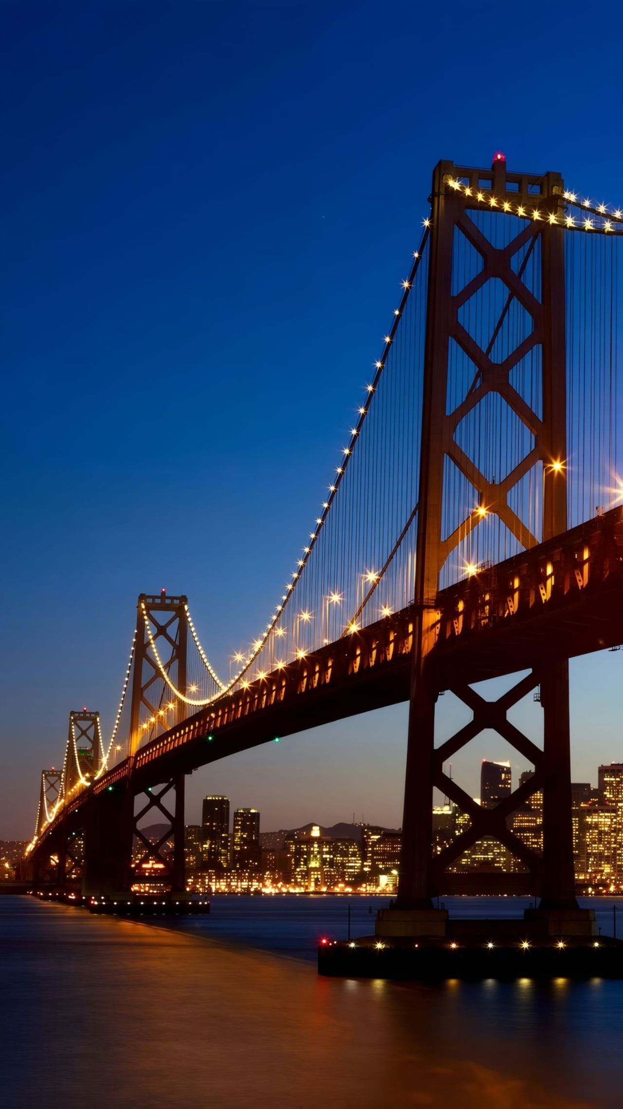 San Francisco Bay Bridge at night with city lights