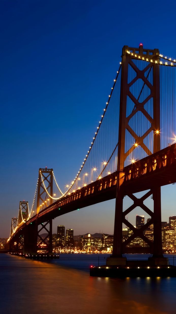 Bay Bridge at night with city lights in the background, San Francisco