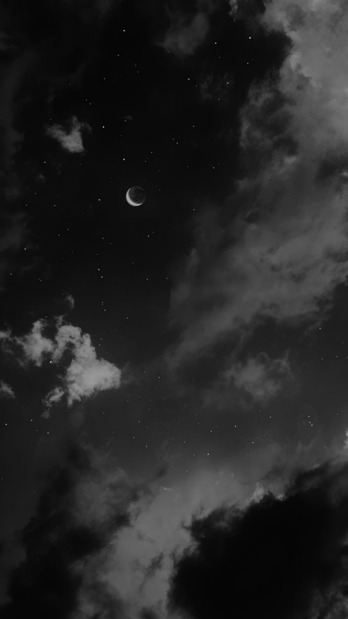 Monochrome image of crescent moon, clouds, and stars in the night sky