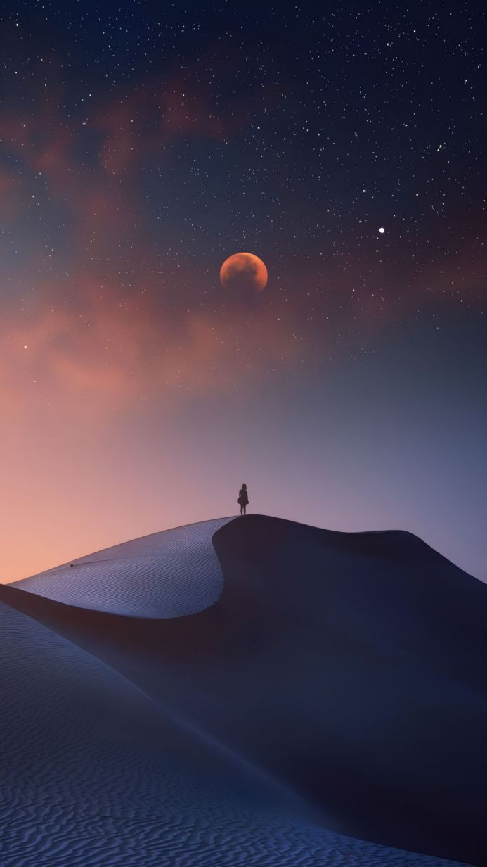 Person on a sand dune at night with a large moon and stars