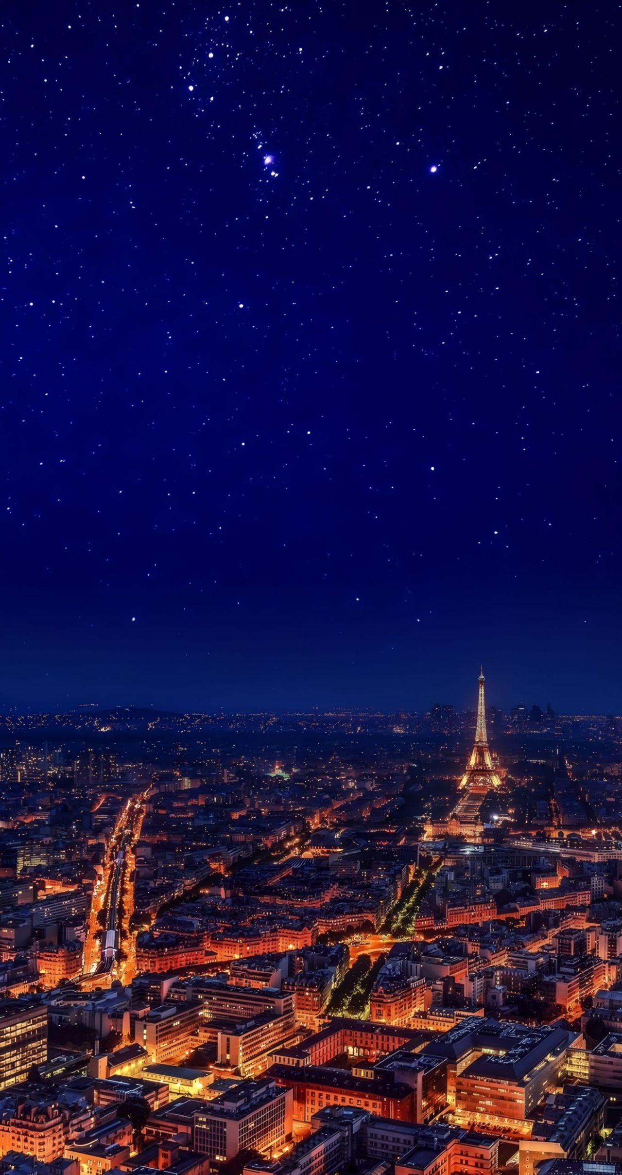 Paris city skyline at night with Eiffel Tower and stars