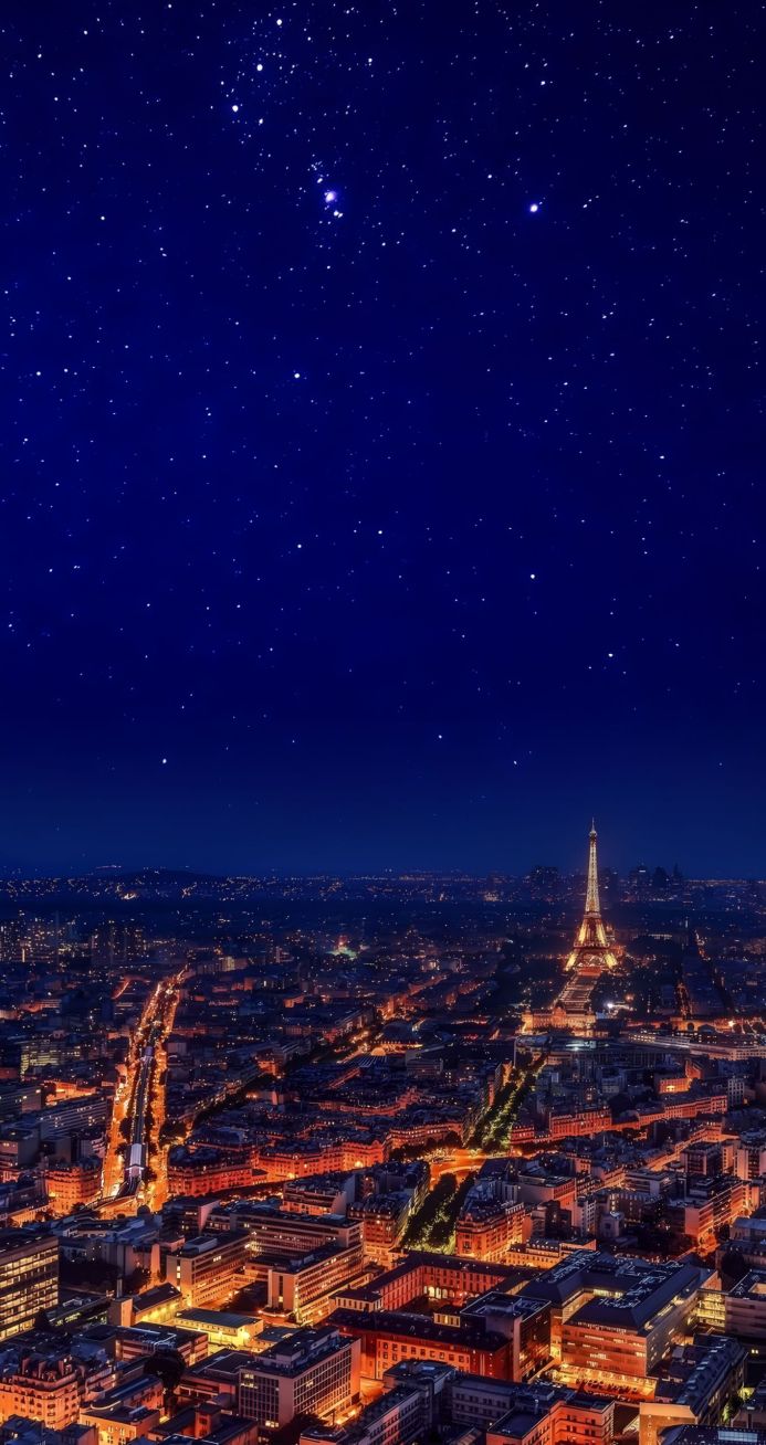Eiffel Tower at night with city lights and stars