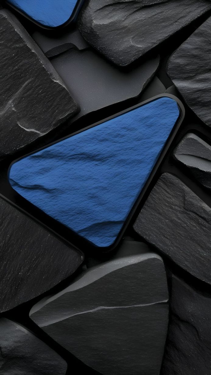 A close-up of gray stones surrounding a blue, water-like shape