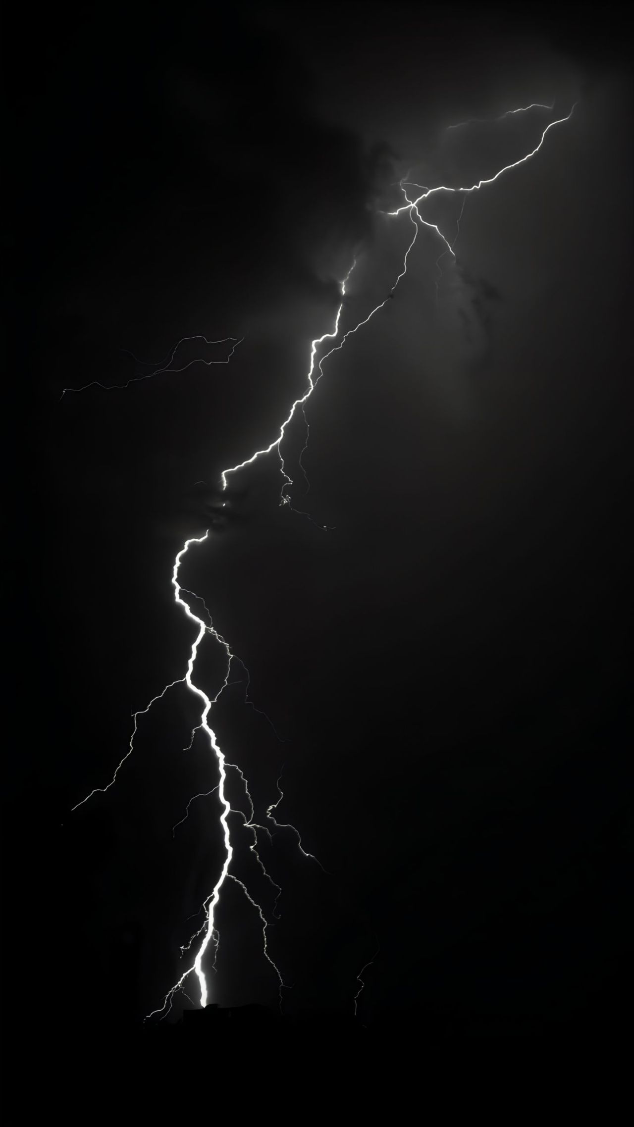 Bright lightning strike in a dark stormy night sky