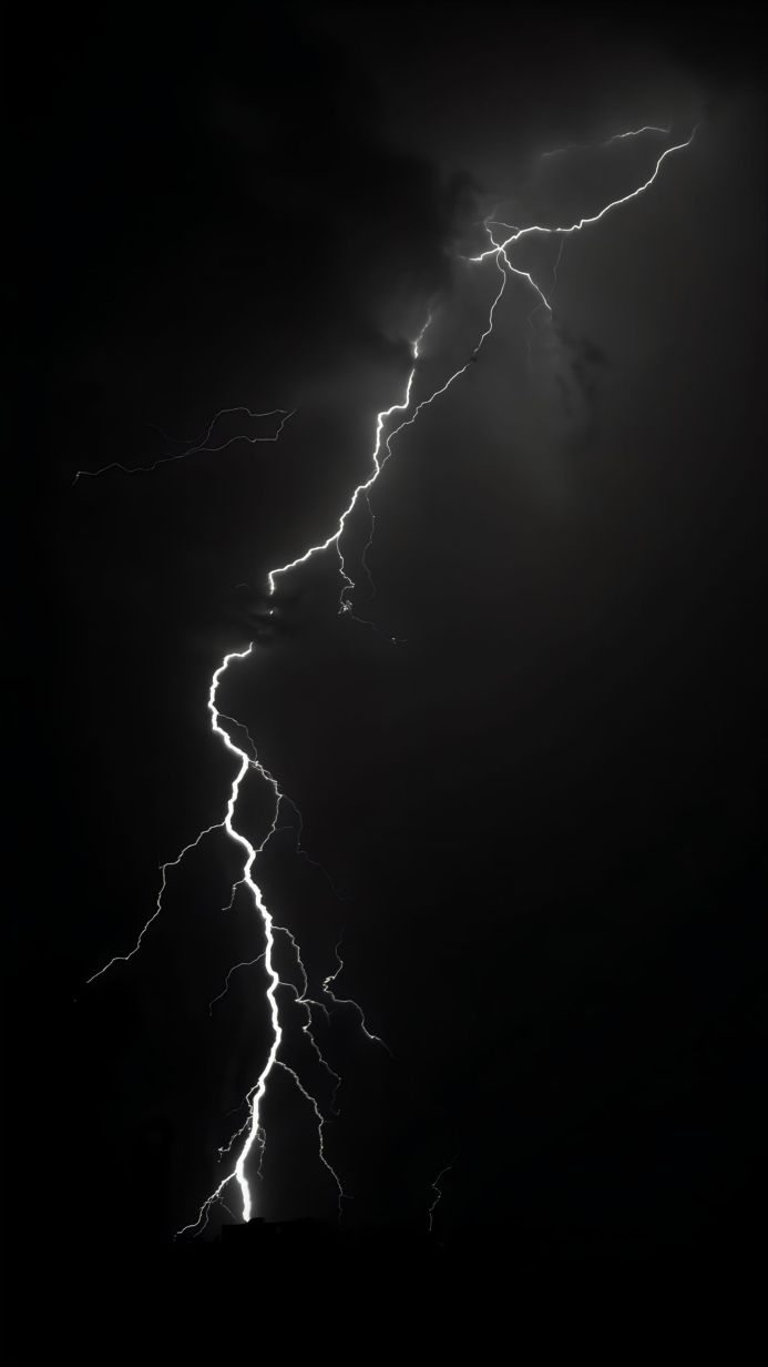 A bright lightning bolt strikes through the night sky