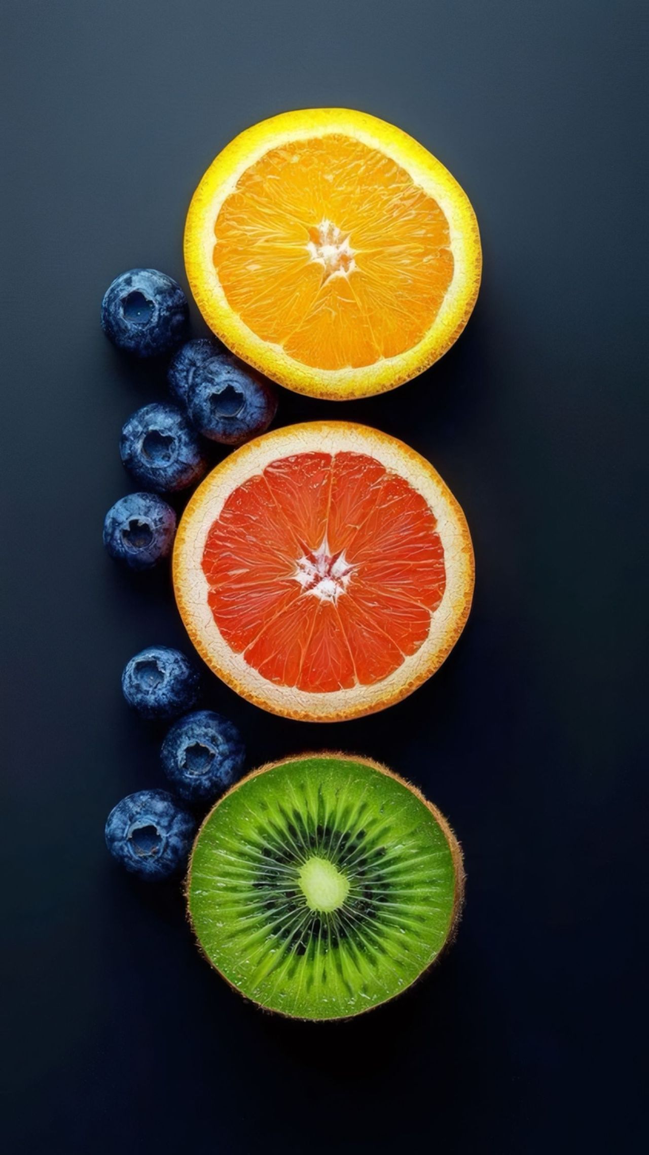 Slices of orange grapefruit kiwi and blueberries dark background