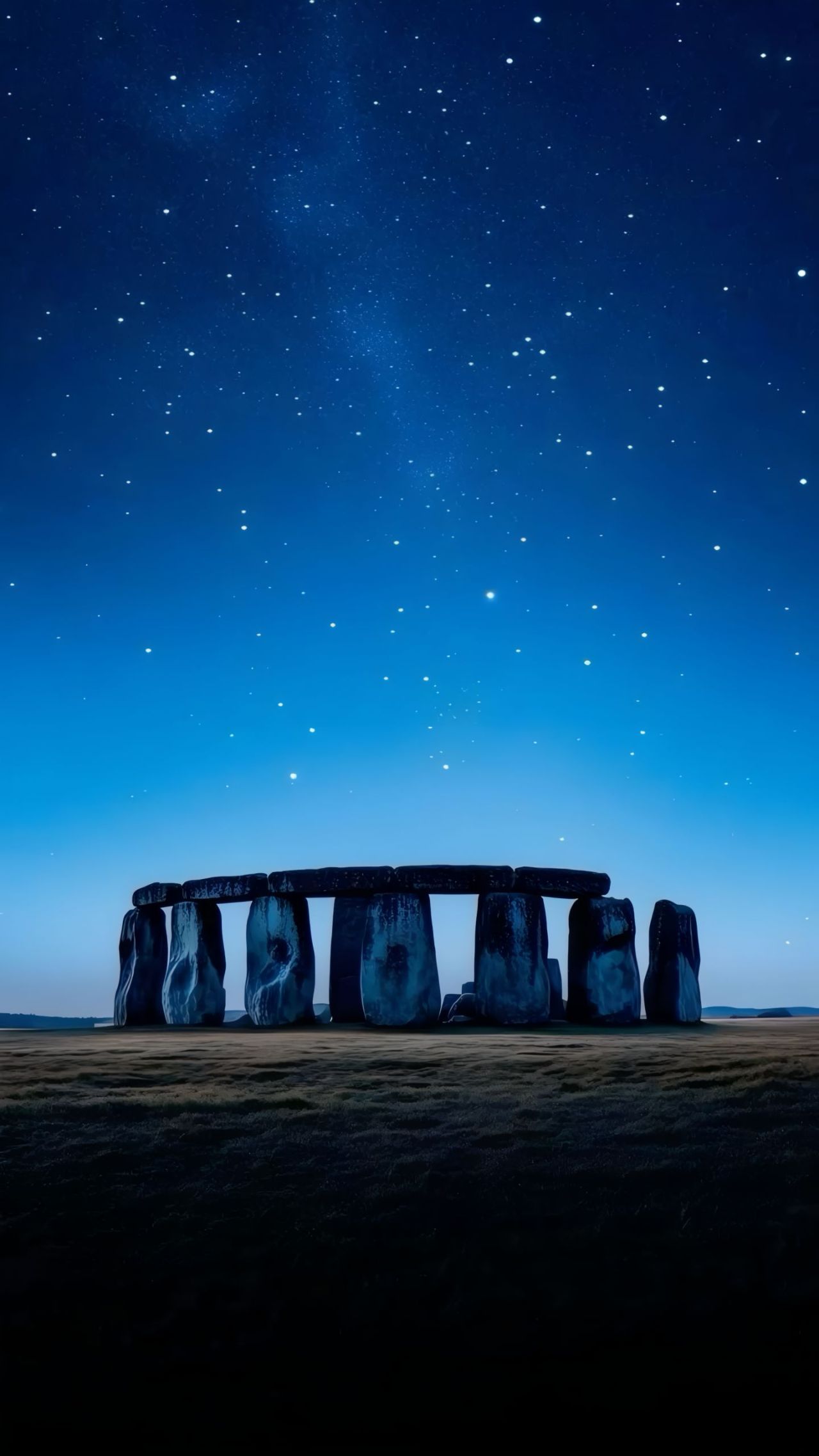 Stonehenge at night under a starry sky