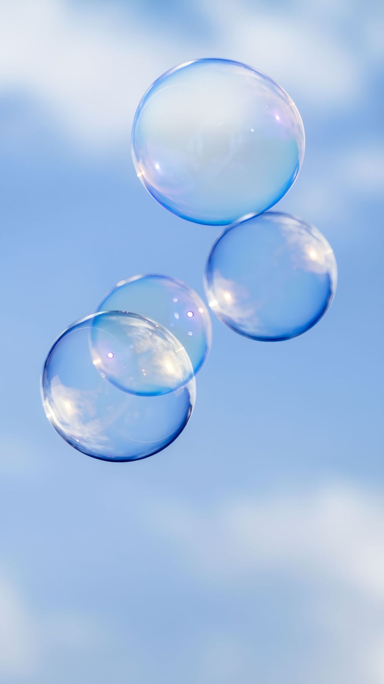 Soap bubbles floating against a blue sky