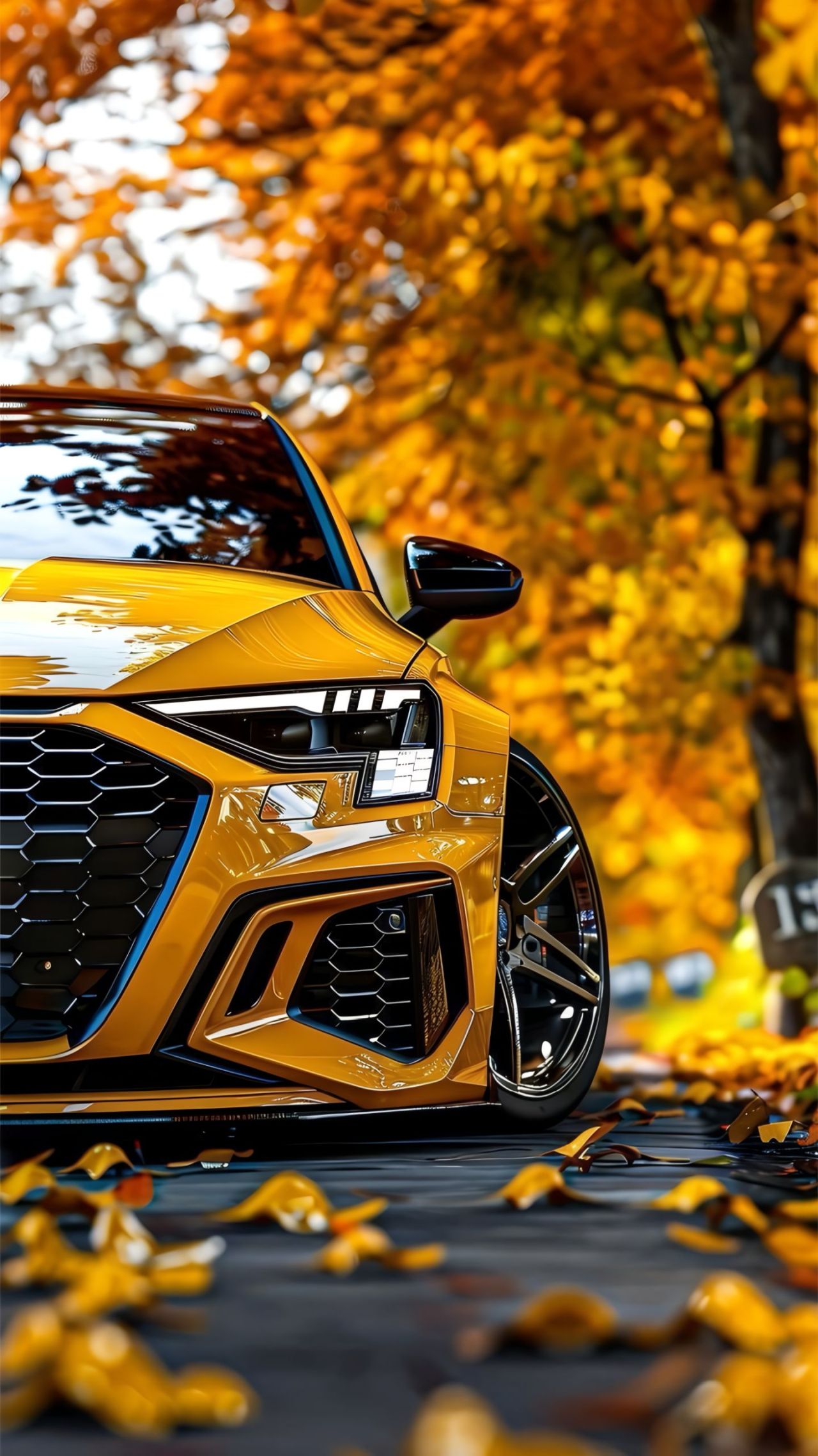 Yellow sports car parked on autumn path with golden leaves